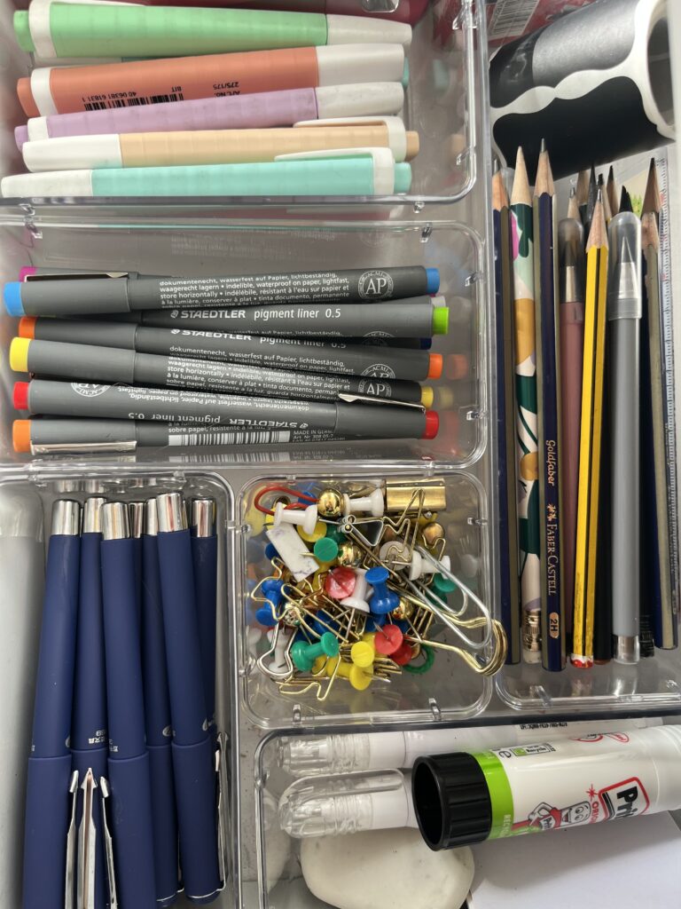 Tidy desk drawers with office supplies and stationery organisers