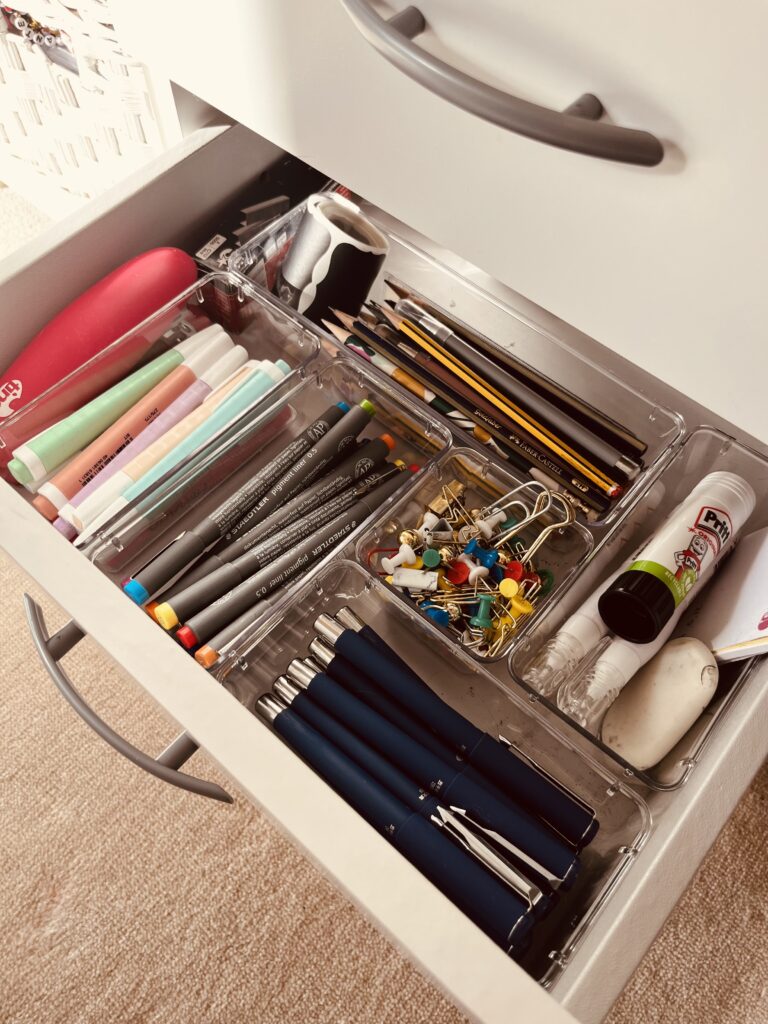 Tidy desk drawers with office supplies and stationery organisers