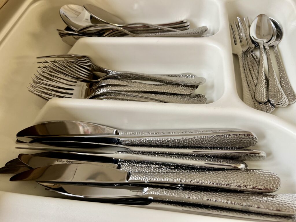 Organised kitchen drawers with dividers and utensils for efficient storage