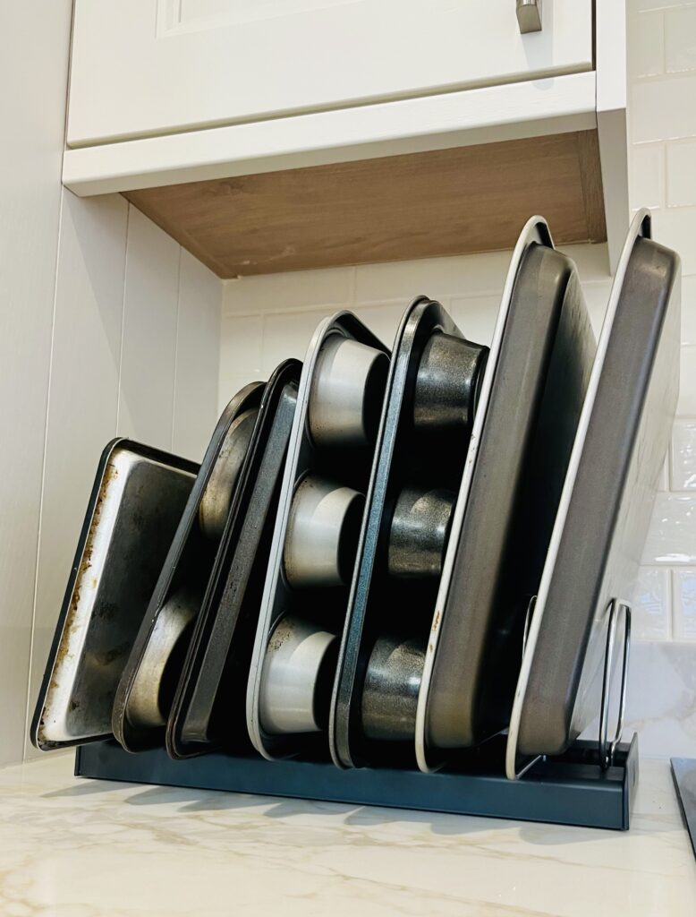 Organised baking trays and sheet pans in vertical storage rack