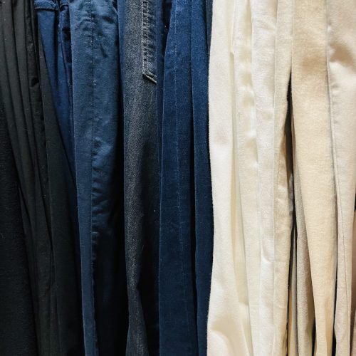 Colour-coded organised wardrobe with matching hangers